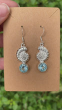 Load and play video in Gallery viewer, Sterling Silver Nautilus Shell With Faceted Blue Topaz Earrings
